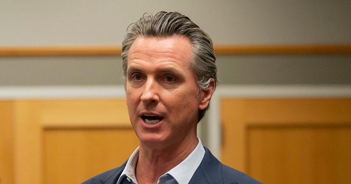 California Gov. Gavin Newsom speaks during a tour of a cooling center with Sacramento Mayor Darrell Steinberg at the Tsakopoulos Library Galleria on Aug. 18, 2020, in Sacramento, California.