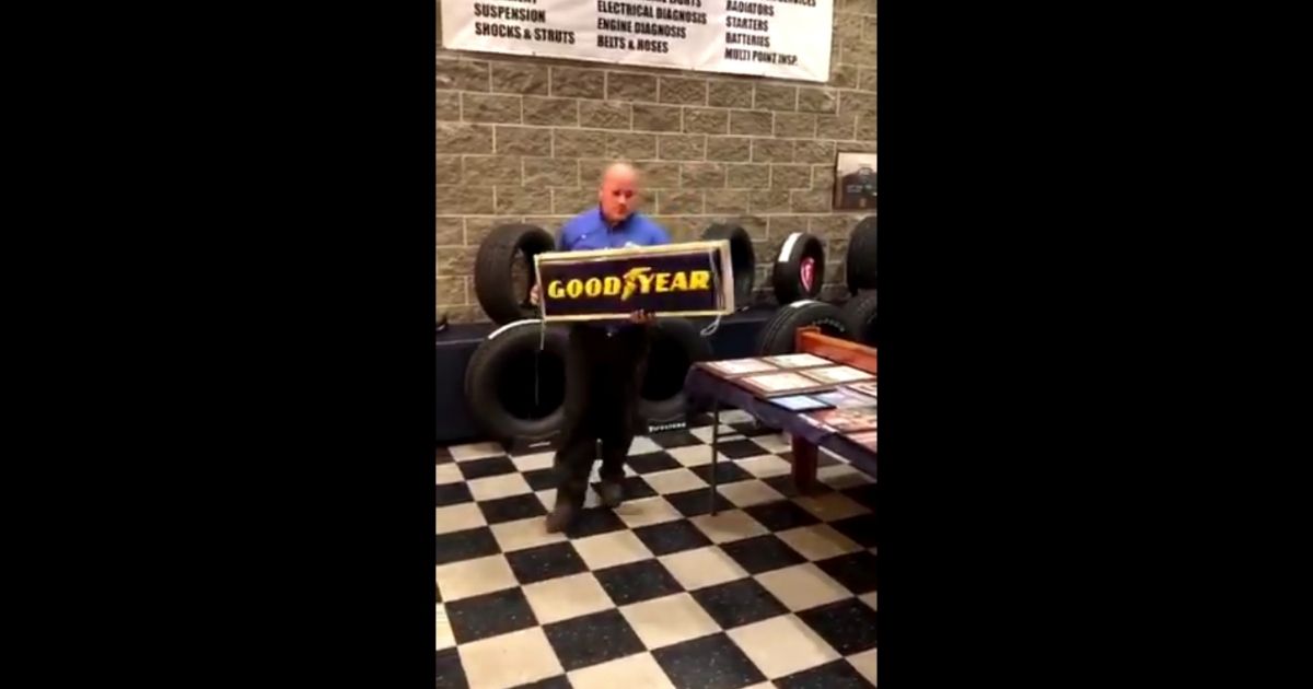 Bret Balswick, the owner of Balswick's Tire & Auto Service & Detail in Turlock, California, takes down a Goodyear tires sign.