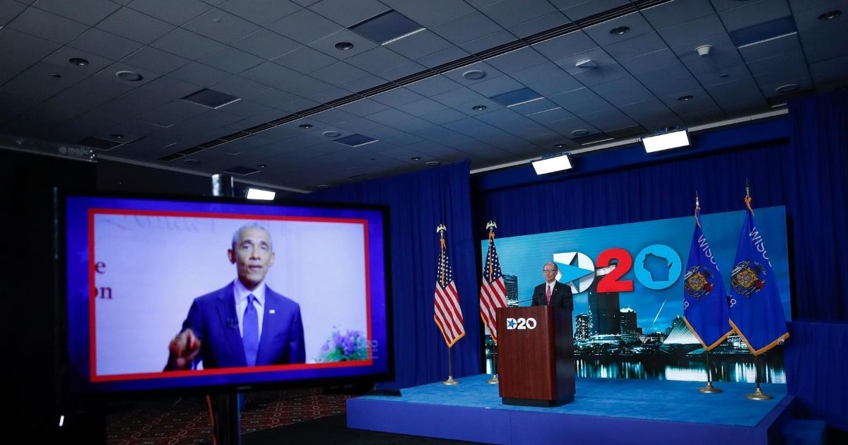 A screen plays a video of former President Barack Obama speaking as Tom Perez, chairman of the Democratic National Committee, waits to speak in Milwaukee during the four-day convention, which ended on Aug. 20, 2020.