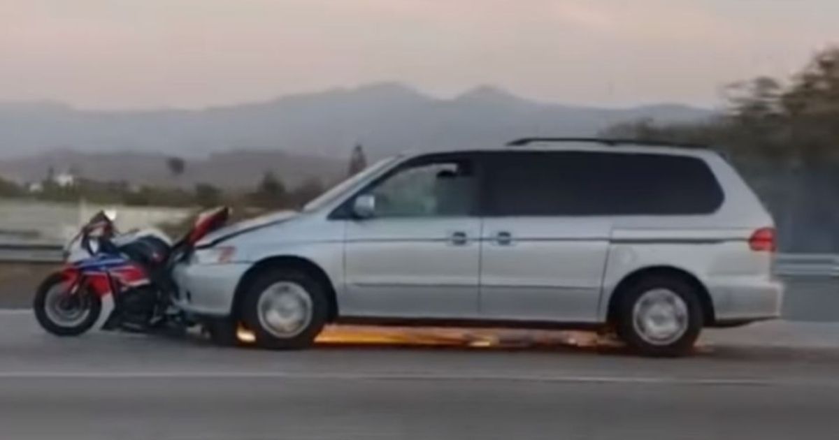 This still picture from a video shows a minivan dragging a motorcycle down a California highway earlier this summer.