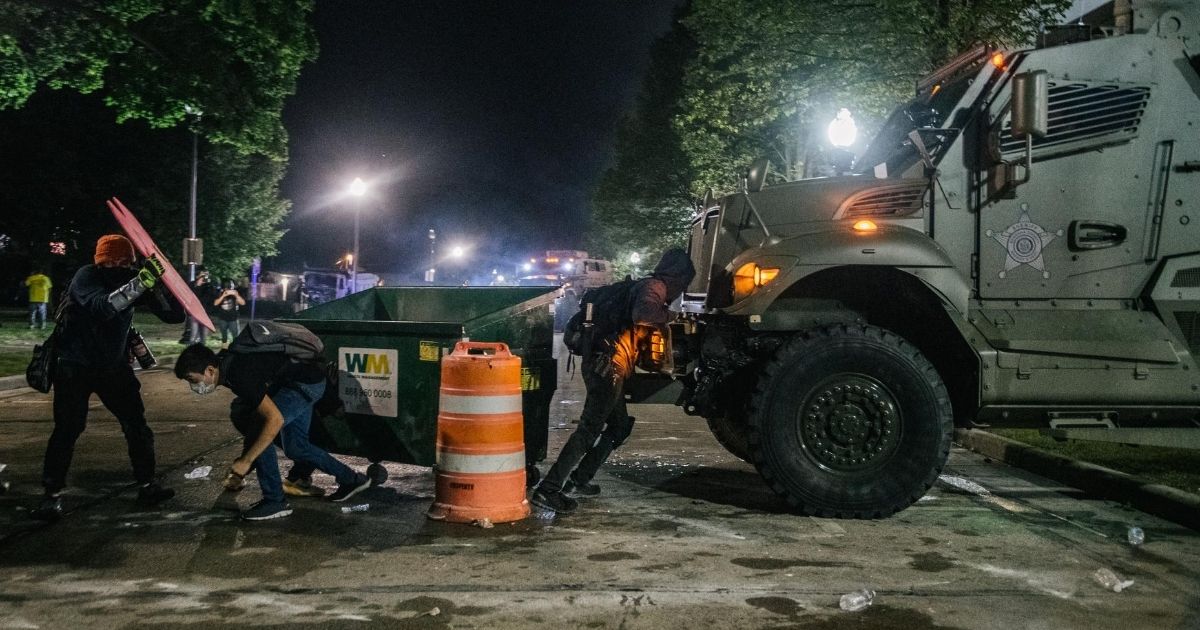 Demonstrators attempt to block an armored police vehicle on Aug. 25, 2020, in Kenosha, Wisconsin.