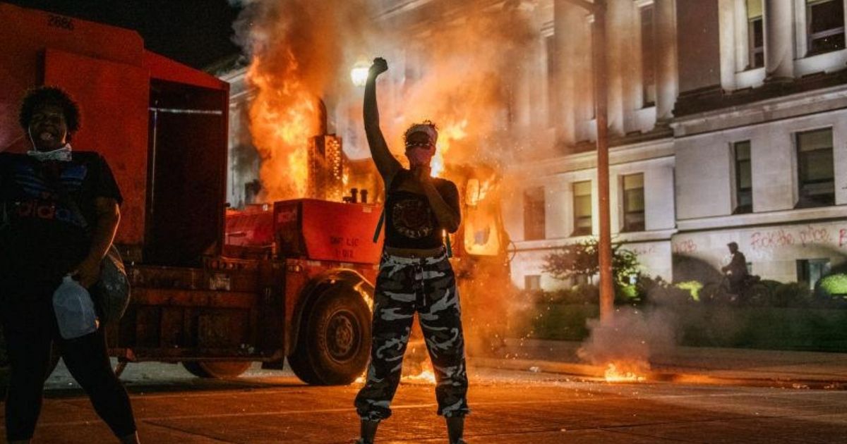Demonstrators chant in front of a burning truck on Aug. 24, 2020 in Kenosha, Wisconsin.