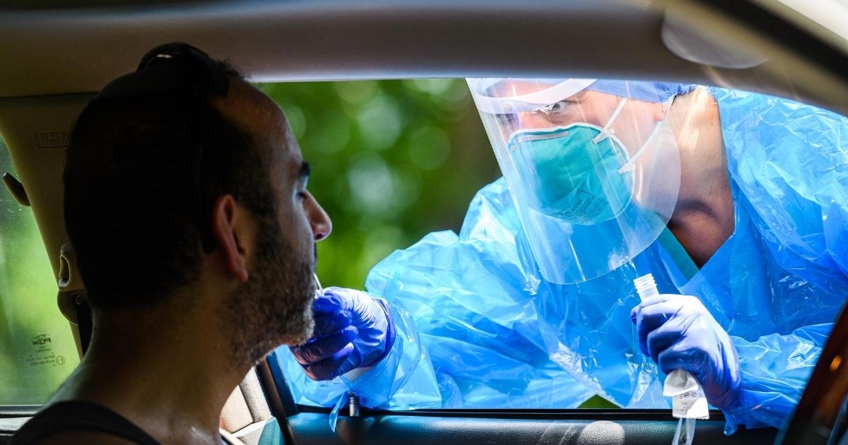 A health care worker peforms nasal swab tests for COVID-19 on New York City's Upper West Side in July.