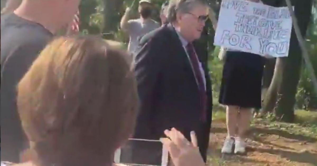 Attorney General William Barr gets out of his car to greet police supporters in Virginia on Aug. 6, 2020.