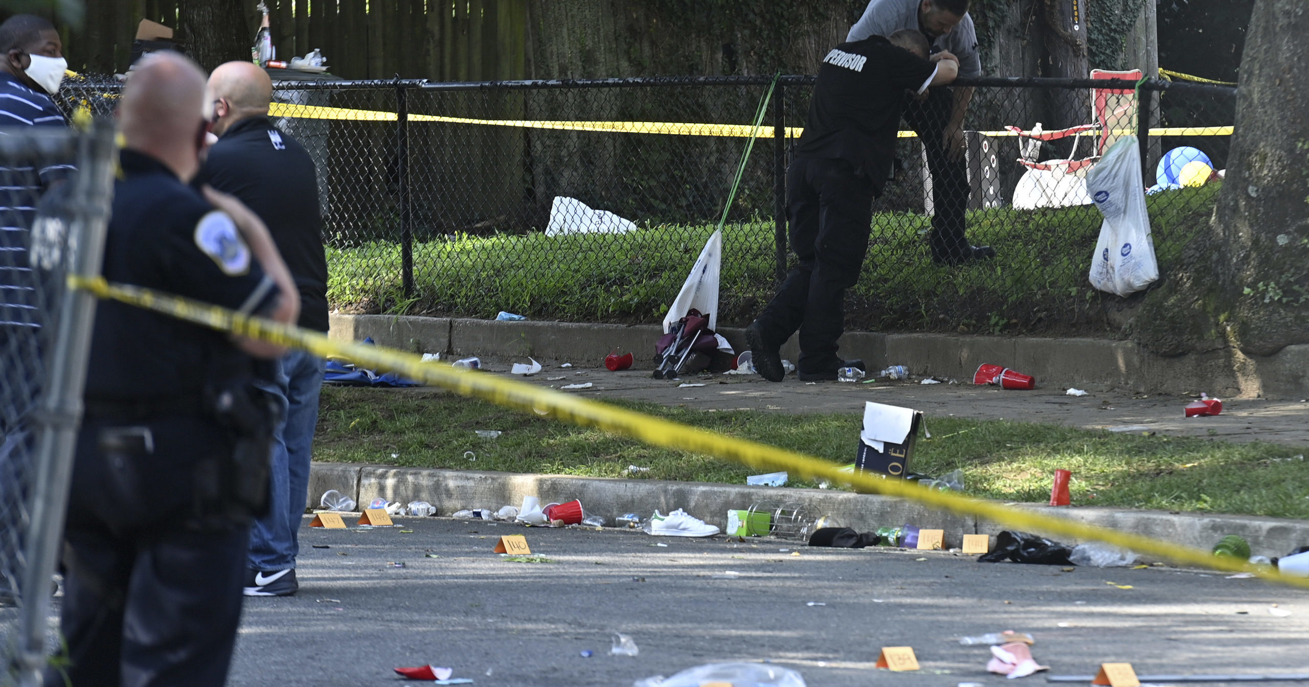 Authorities investigate the scene in Washington, D.C., after a shooting left one dead and 20 wounded on Aug. 9, 2020.
