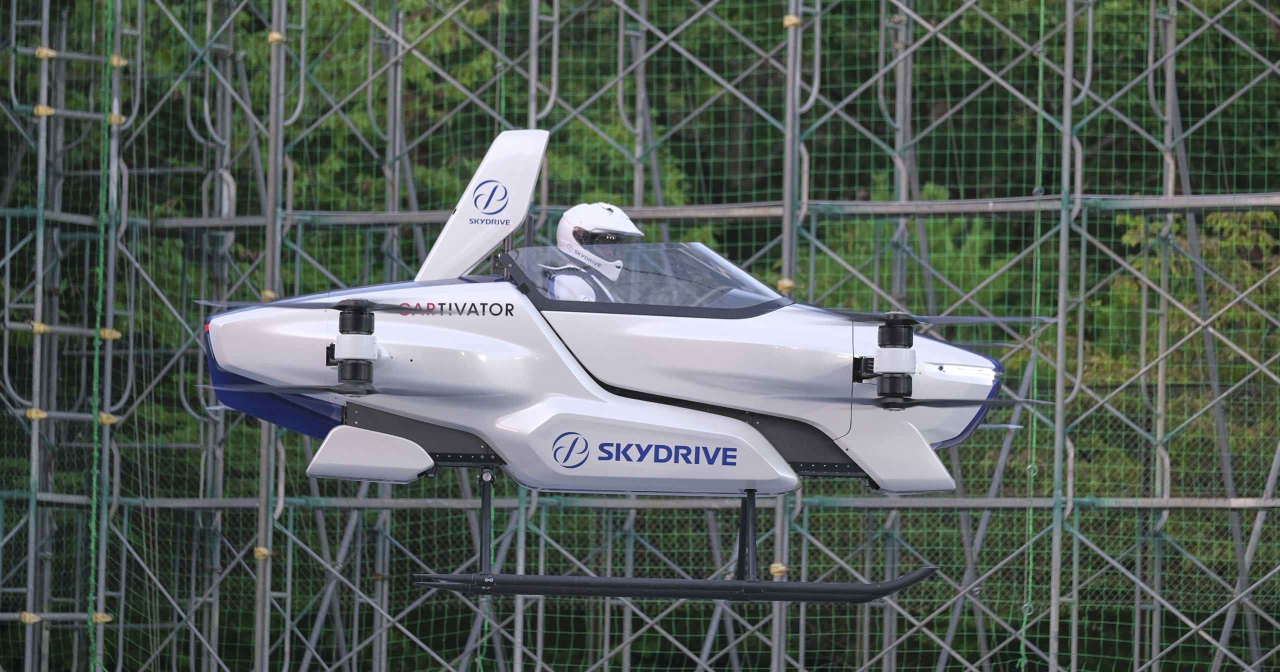 This August 2020 photo released by SkyDrive/CARTIVATOR shows a test flight of a manned "flying car" at Toyota Test Field in Toyota, central Japan. Japan’s SkyDrive Inc. has carried out a successful though modest test flight with one person aboard.