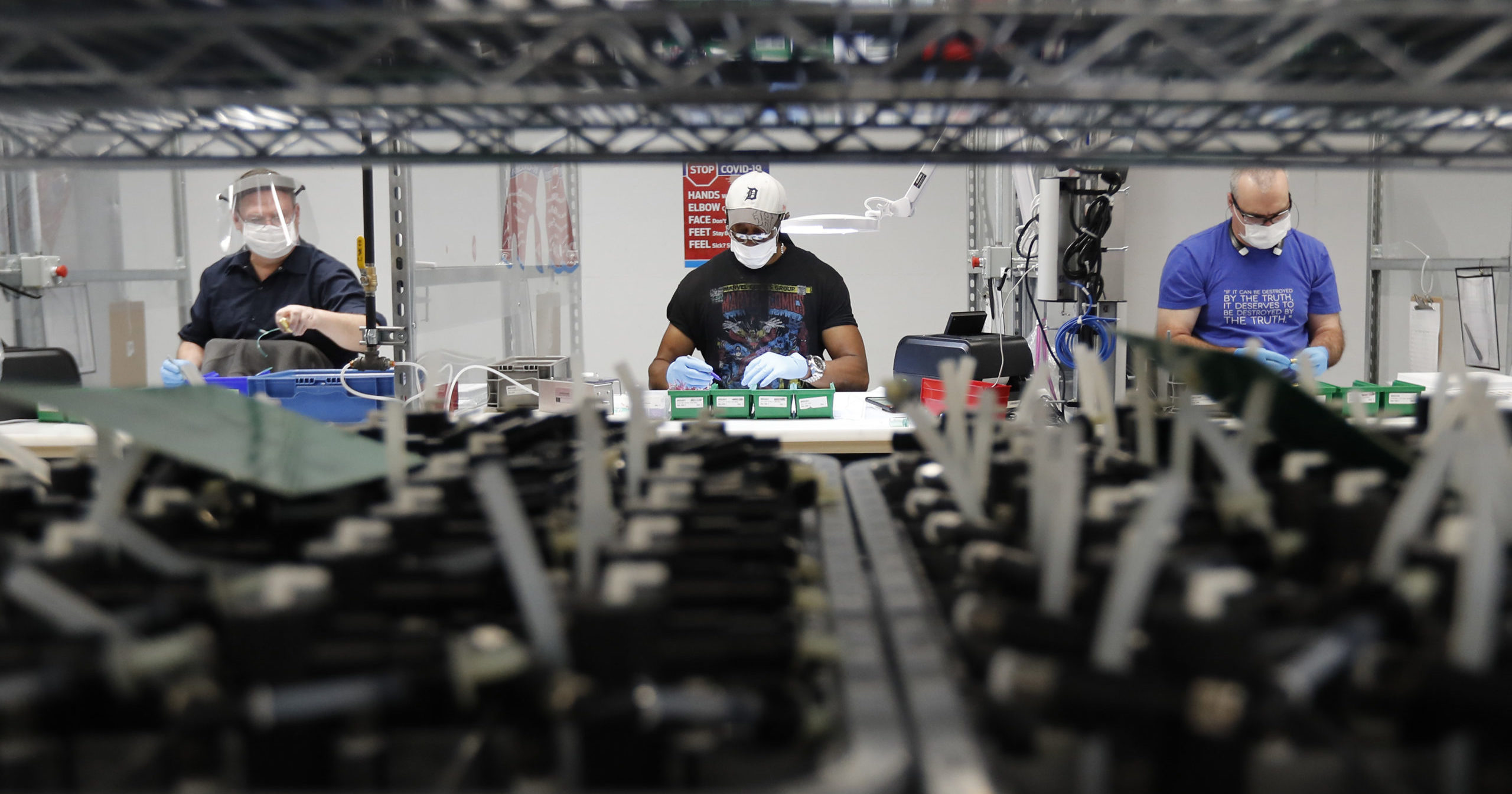 In this May 13, 2020, file photo, line workers put together ventilators at the Ford plant in Ypsilanti Township, Michigan. American industry rebounded last month as factories began to reopen.