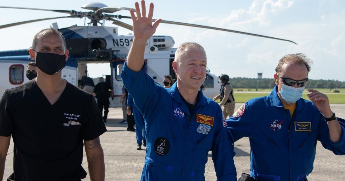 In this image provided by NASA, astronaut Douglas Hurley waves to onlookers in Pensacola, Florida, after landing in the Gulf of Mexico on board SpaceX’s Dragon capsule spacecraft on August 2, 2020.