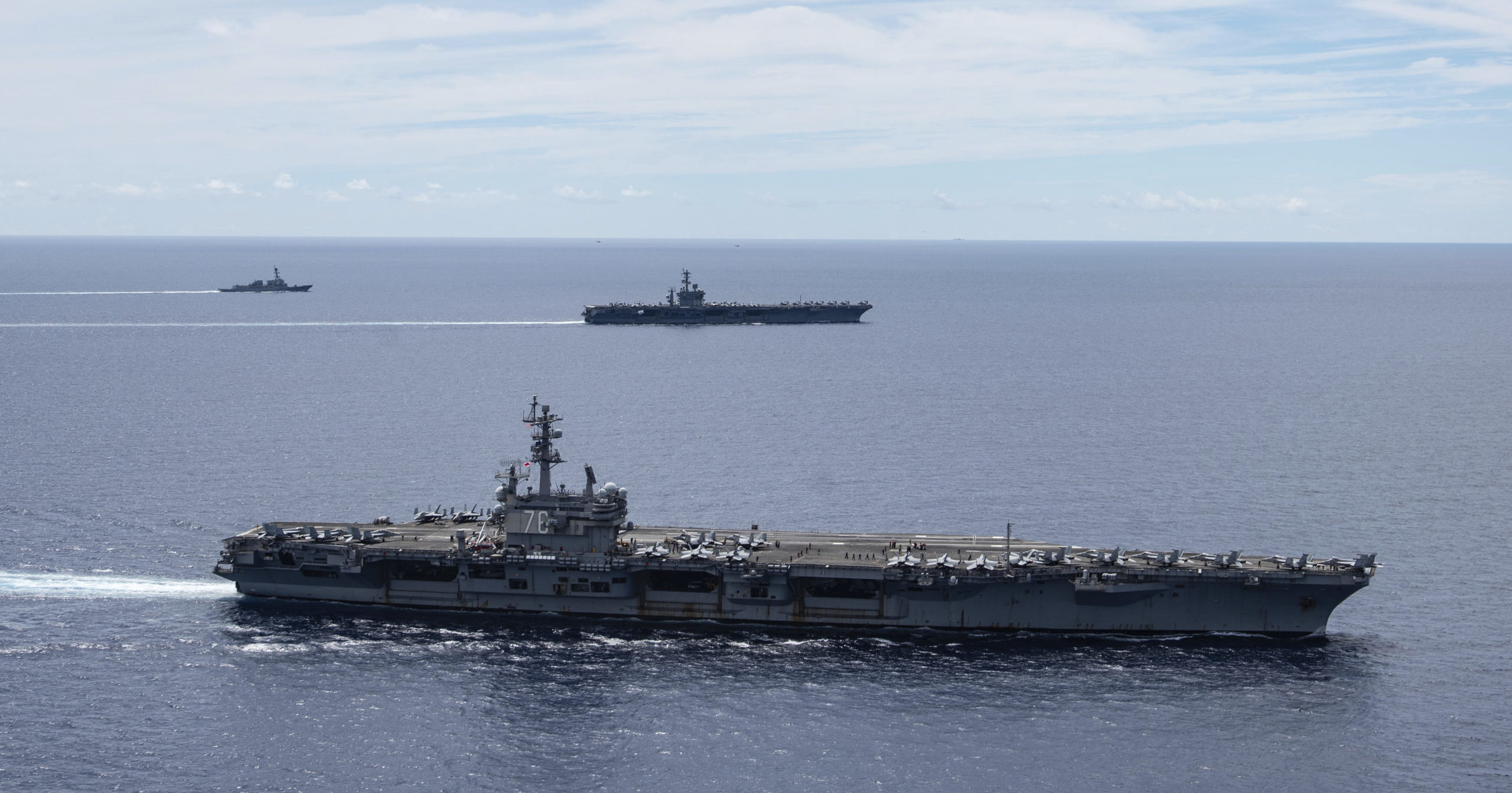 In this July 6, 2020, file photo provided by U.S. Navy, the USS Ronald Reagan and USS Nimitz sail together in formation in the South China Sea.