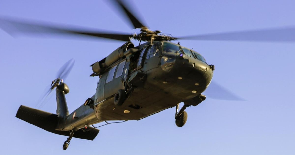 A UH-60 military helicopter flies in this stock image.