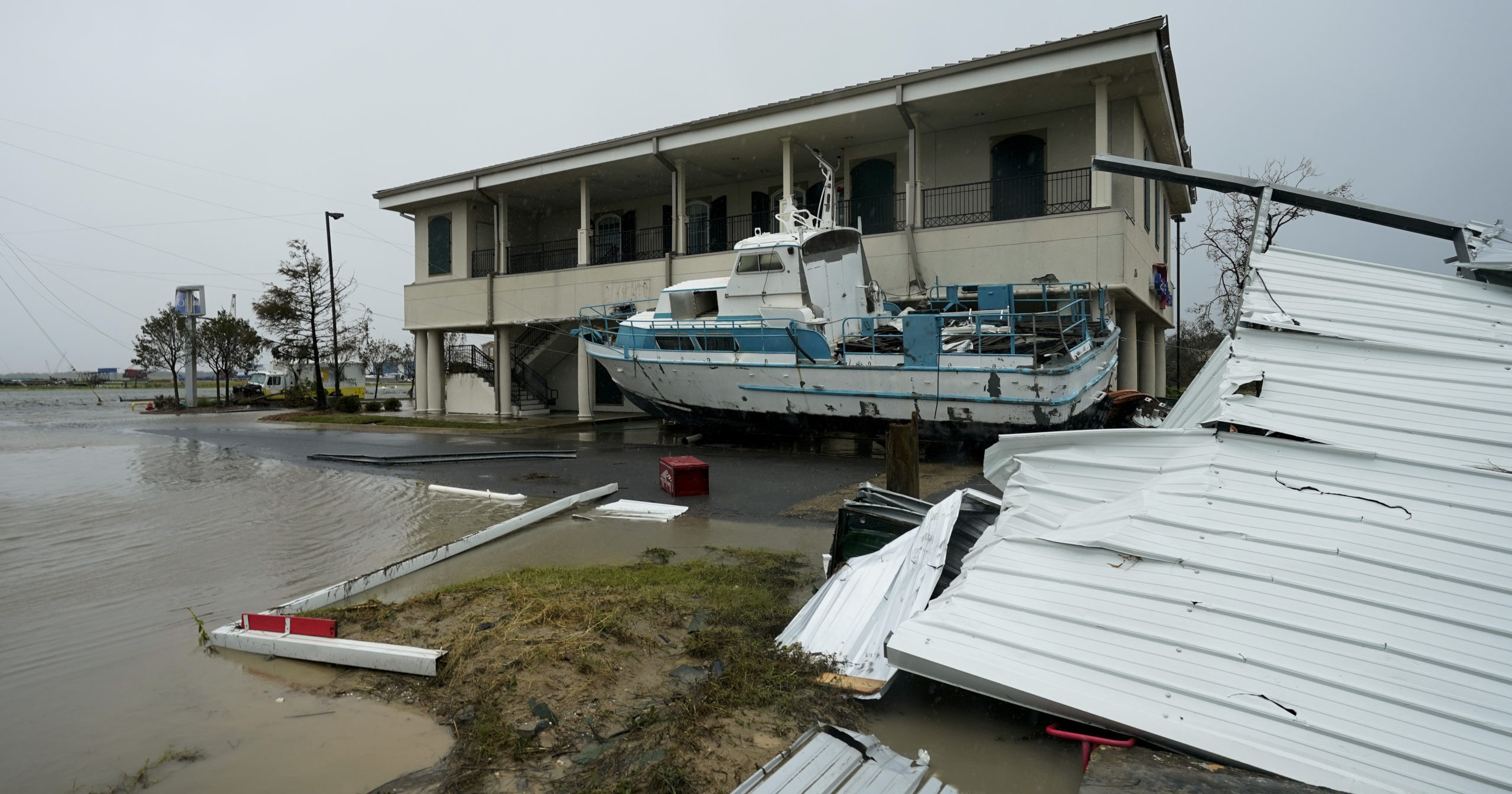 Flooding surrounds a damaged building and boat on Aug. 28, 2020, in Cameron, Louisiana, after Hurricane Laura moved through the area.