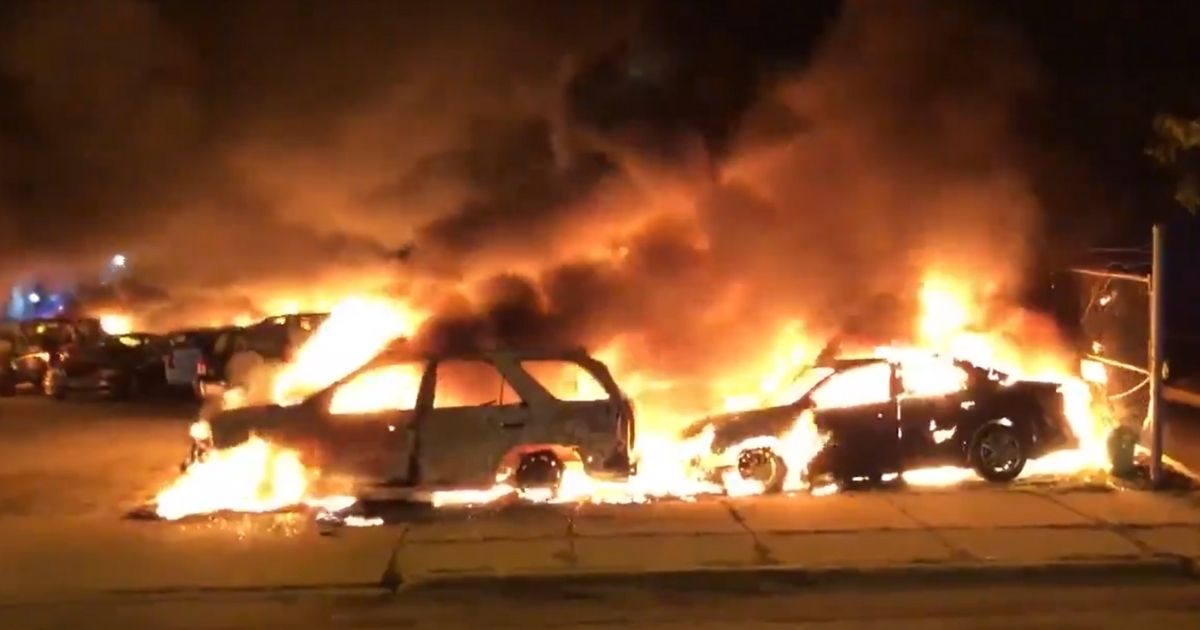 Cars are on fire at a dealership during rioting in Kenosha, Wisconsin.