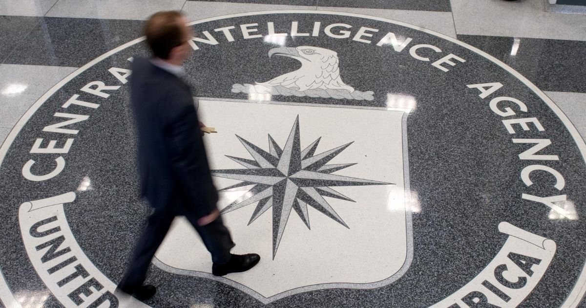 A man crosses the Central Intelligence Agency seal in the lobby of CIA Headquarters in Langley, Virginia, on Aug. 14, 2008.