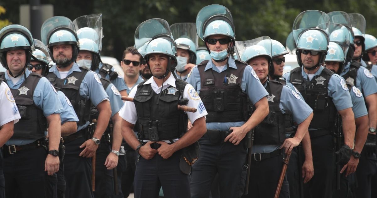 Police officers stand guard as demonstrators stage a rally on Aug. 15, 2020, in Chicago.