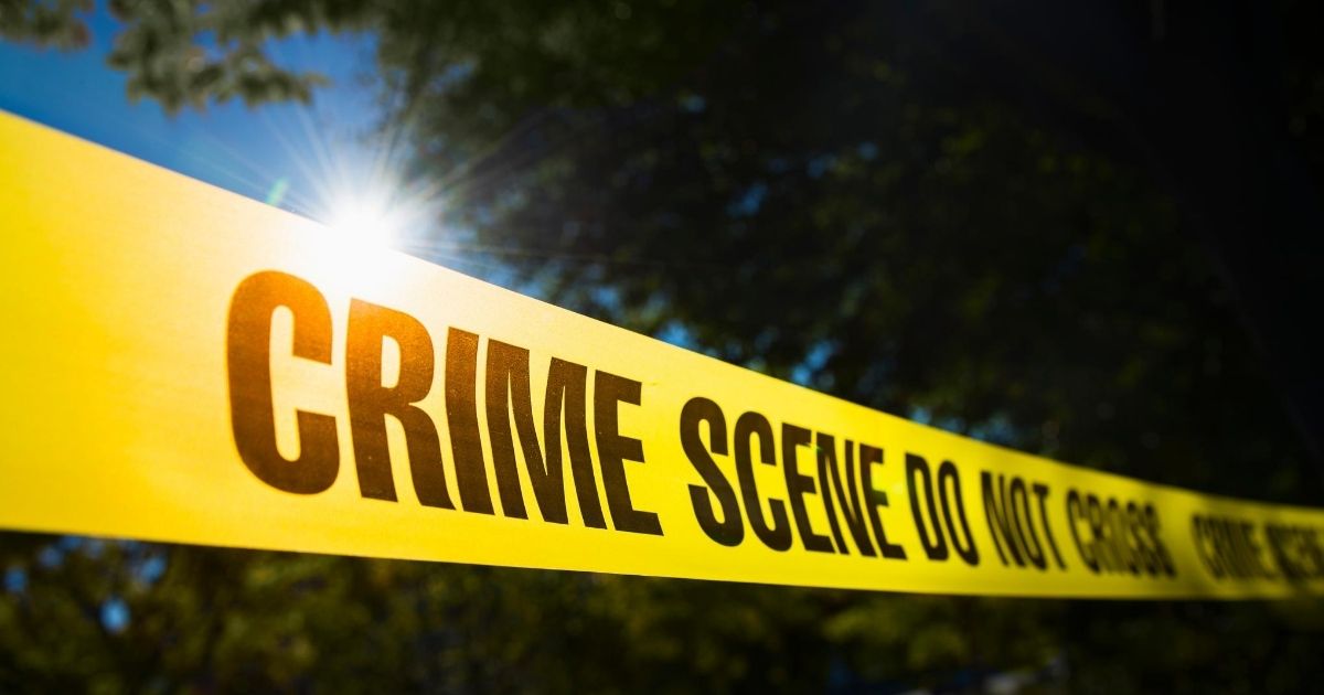 The above stock image shows tape surrounding a crime scene.