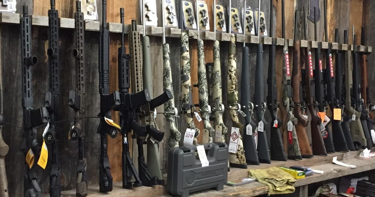 Guns are seen in a store in Wyoming in the stock image above.