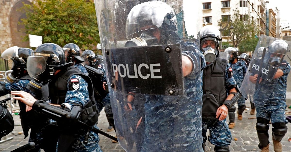 Lebanese security forces advance during clashes with protesters in downtown Beirut on Aug. 8, 2020, following an explosion that killed more than 150 people and devastated the capital city.