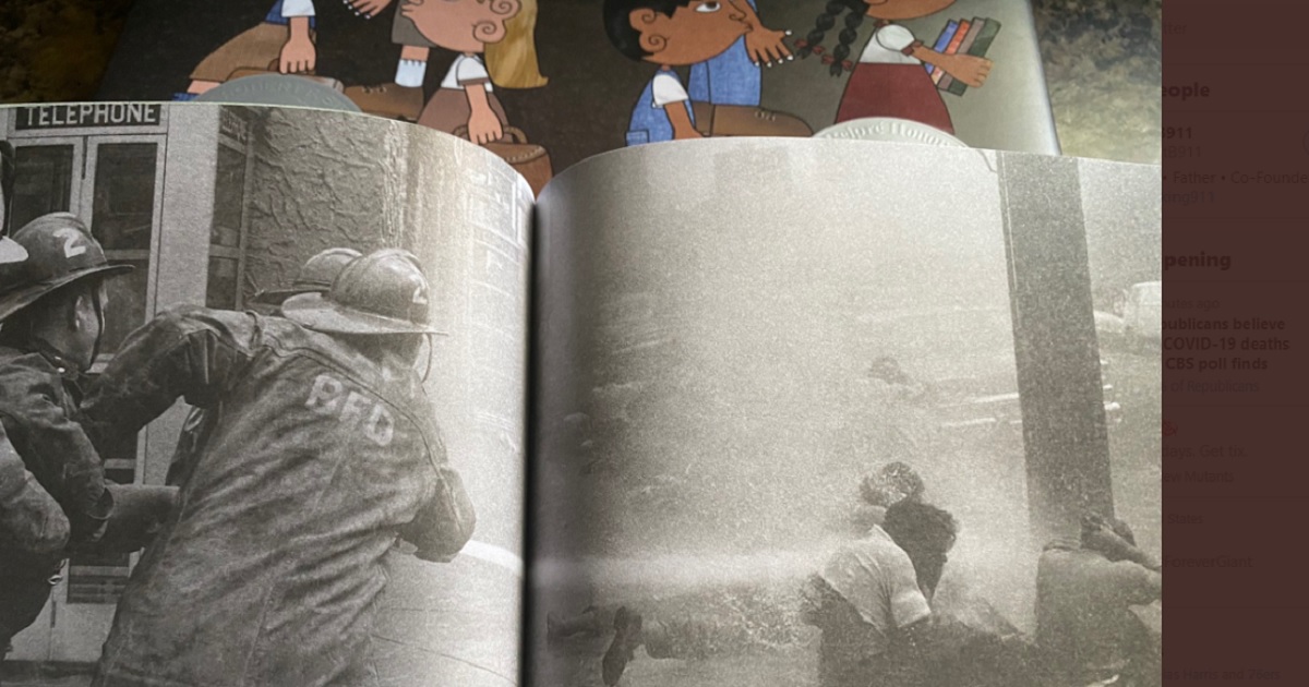 A school textbook shows a historic picture of Birmingham, Alabama, firefighters turning firehoses on civil rights demonstrators.