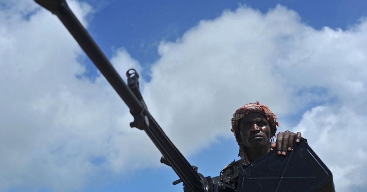 A Somali soldier holds a machine gun at a military base where an American special operations soldier was killed by a mortar attack south of Mogadishu, Somalia, on June 13, 2018