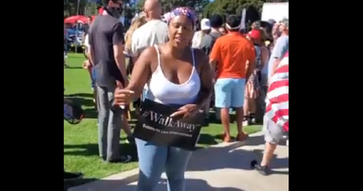 A participant in a Sunday rally for the #WalkAway movement in Beverly Hills tells an questioner that race is unimportant, because she's American.