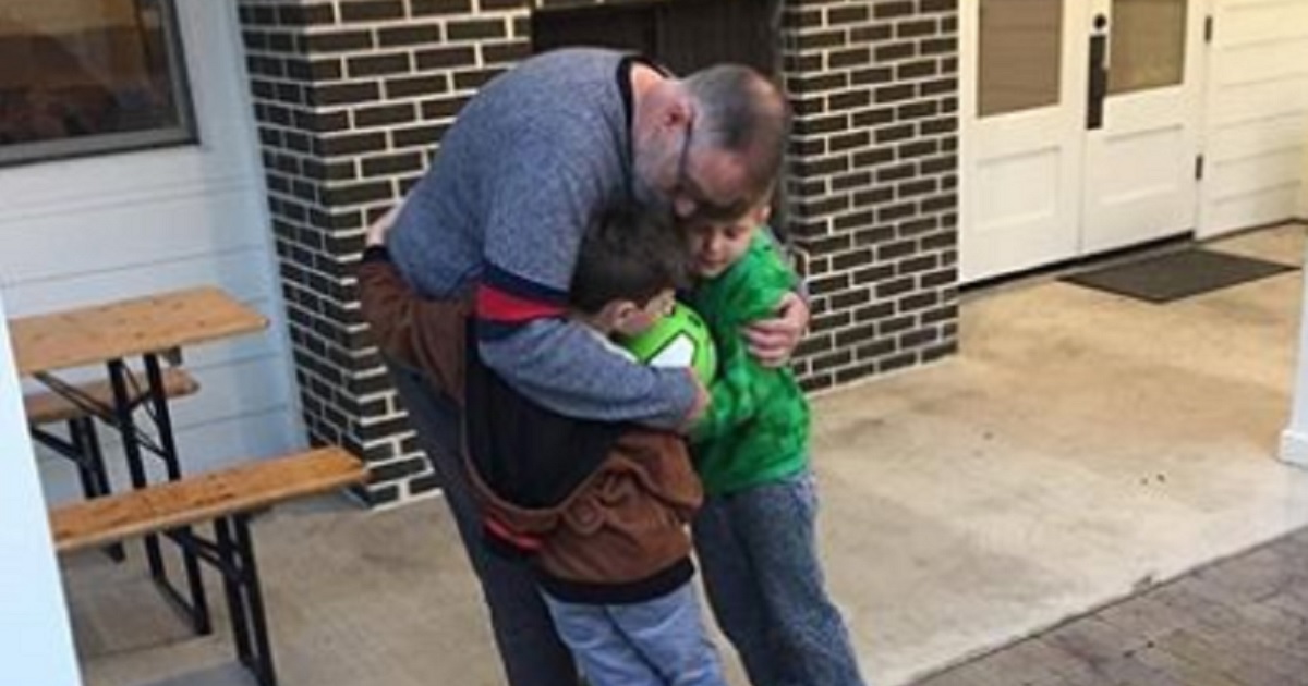 Jeffrey Younger hugs his twin sons, Jude and James, in a picture taken from Facebook.