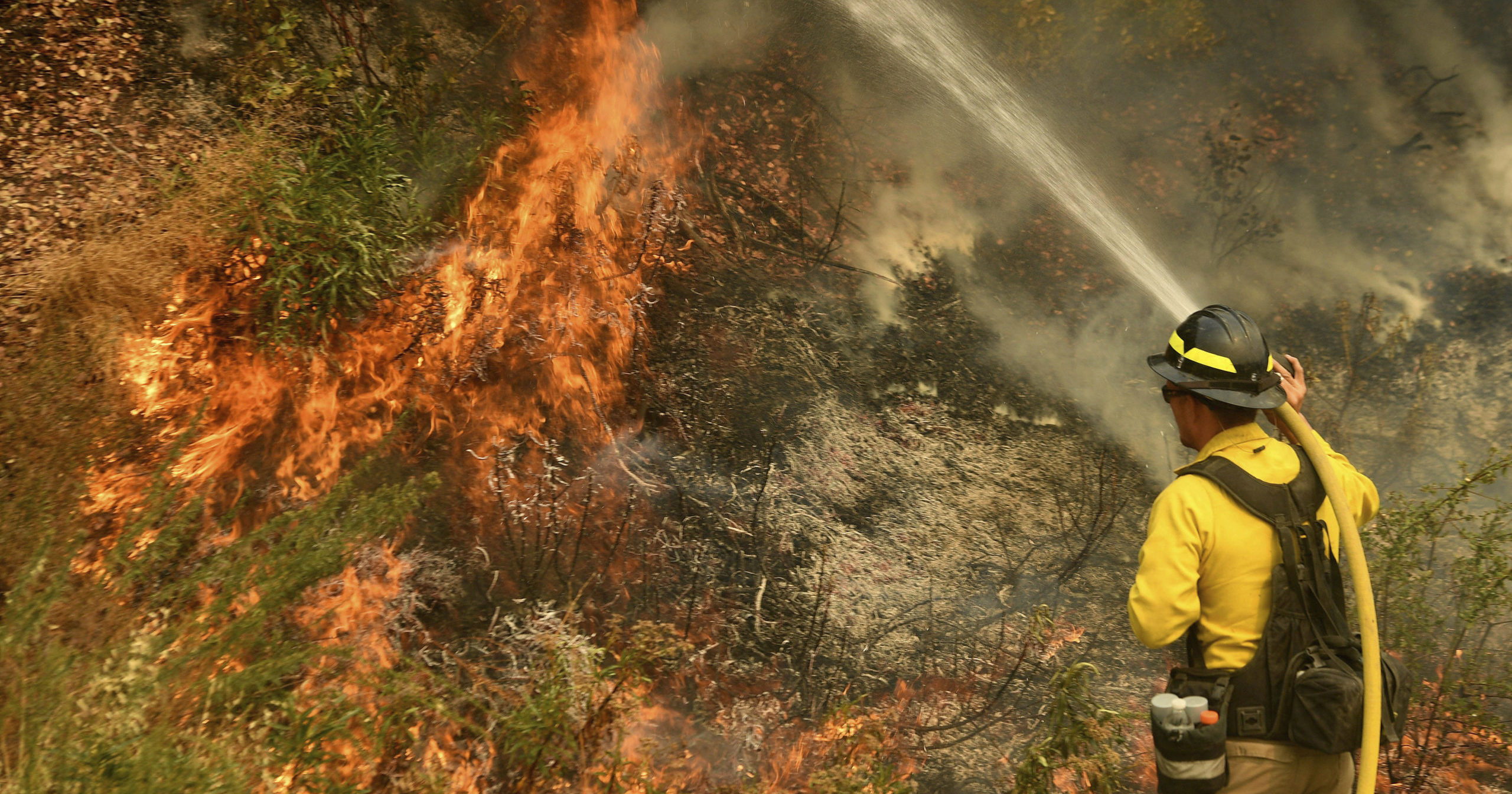 A firefighter puts out a fire northwest of Forrest Falls, California, on Sept. 10, 2020.