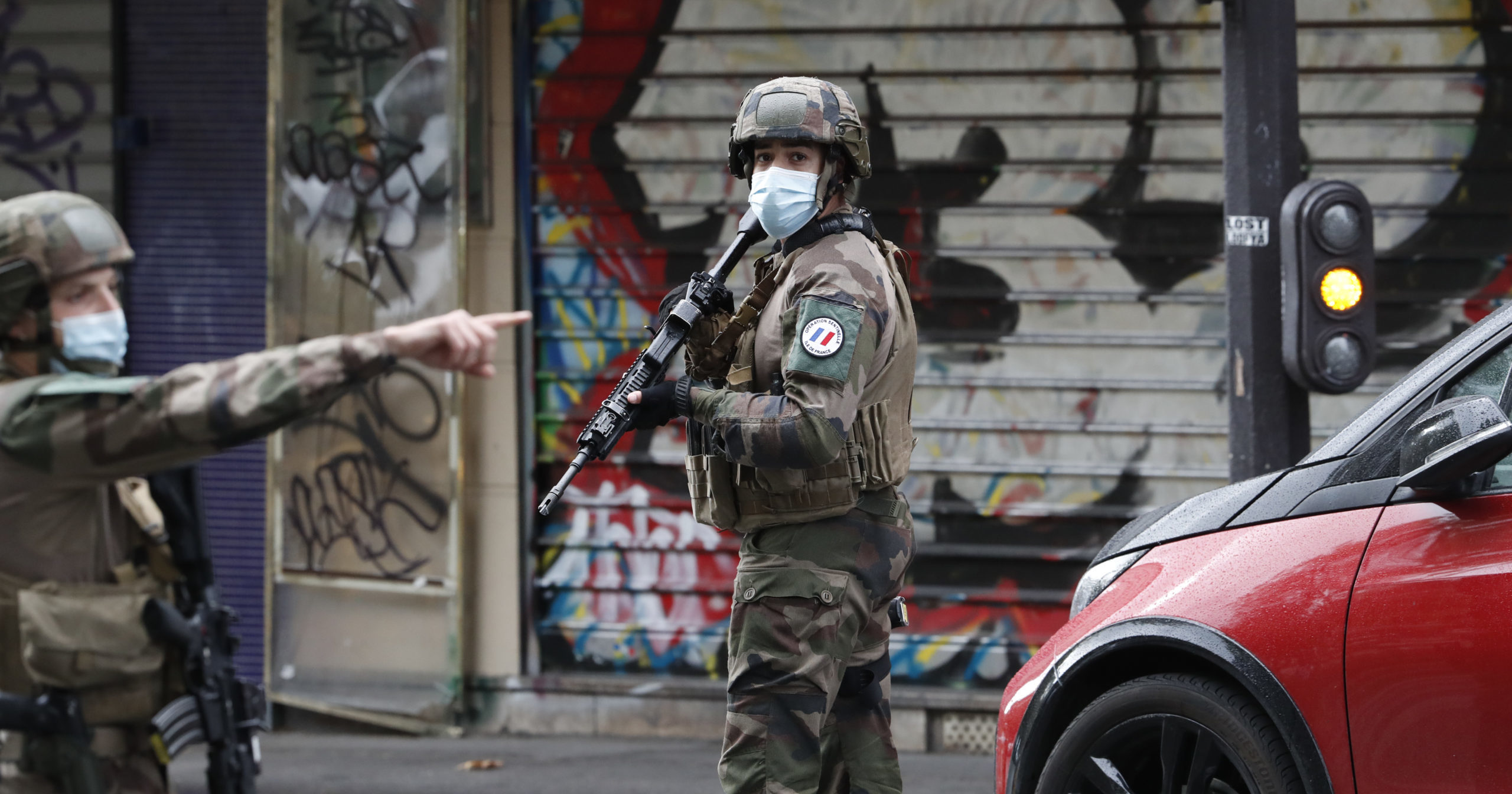 French soldiers patrol after a knife attack near the former offices of satirical newspaper Charlie Hebdo on Sept. 25, 2020, in Paris.