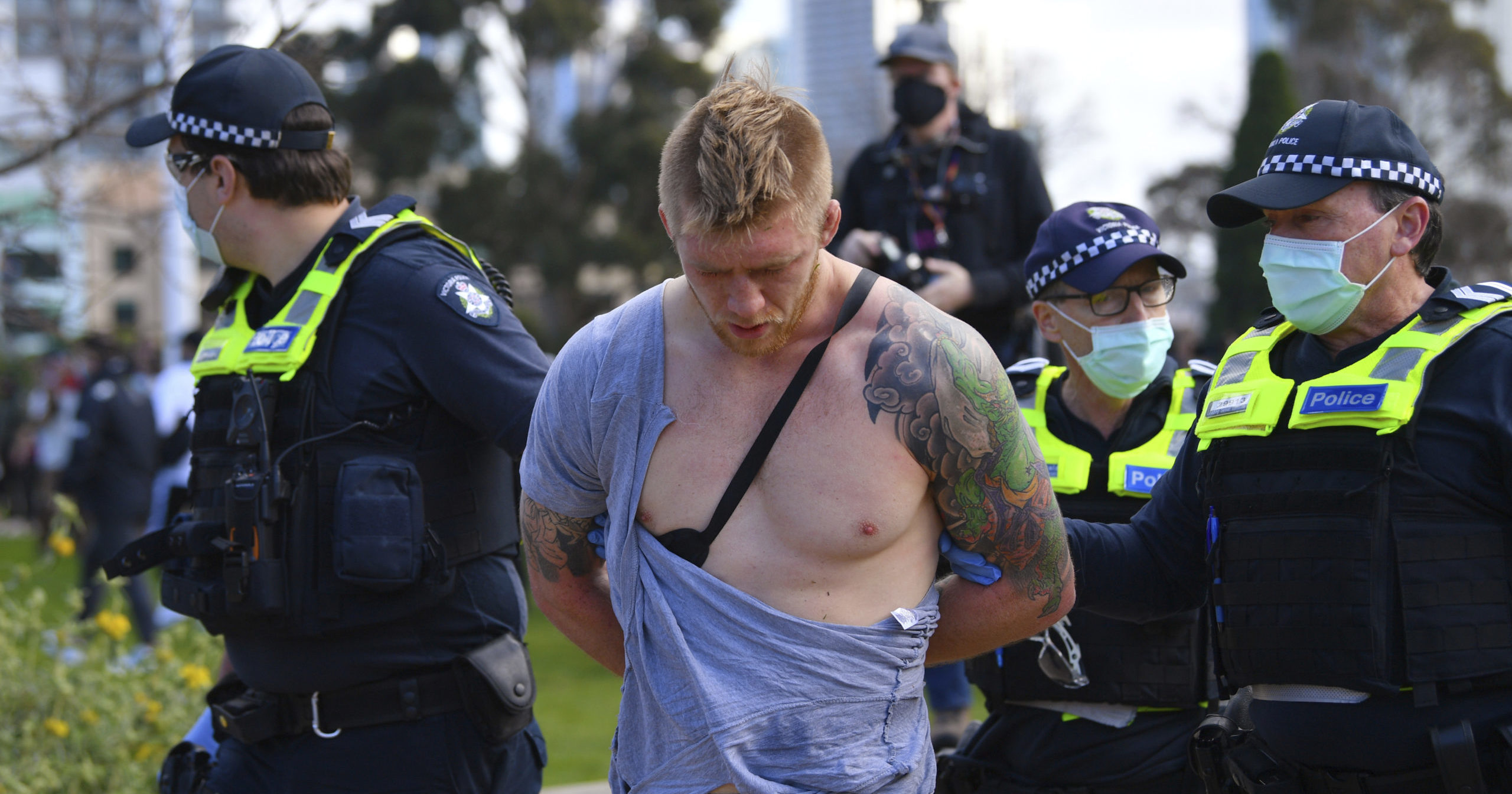 Police arrest a man as people gather at a protest against lockdown measures in Melbourne, Australia, on Sep. 5, 2020.