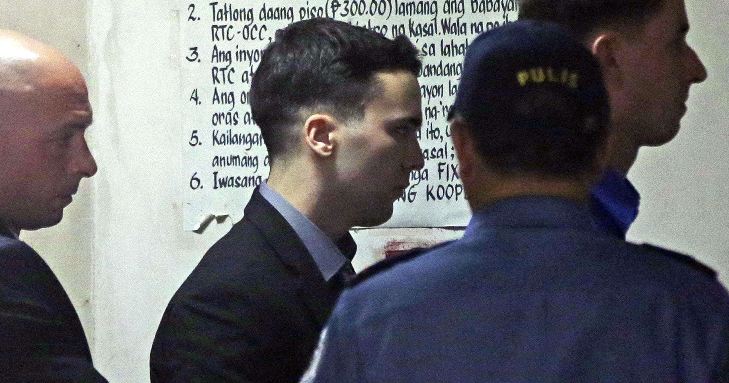 In this Dec. 1, 2015, file photo, U.S. Marine Lance Cpl. Joseph Scott Pemberton, center, is escorted as he arrives at court before his conviction of homicide for killing Filipino transgender Jennifer Laude in Olongapo, northwest of Manila, Philippines. A Philippine court has on Sept. 2, 2020, ordered his early release for good conduct.
