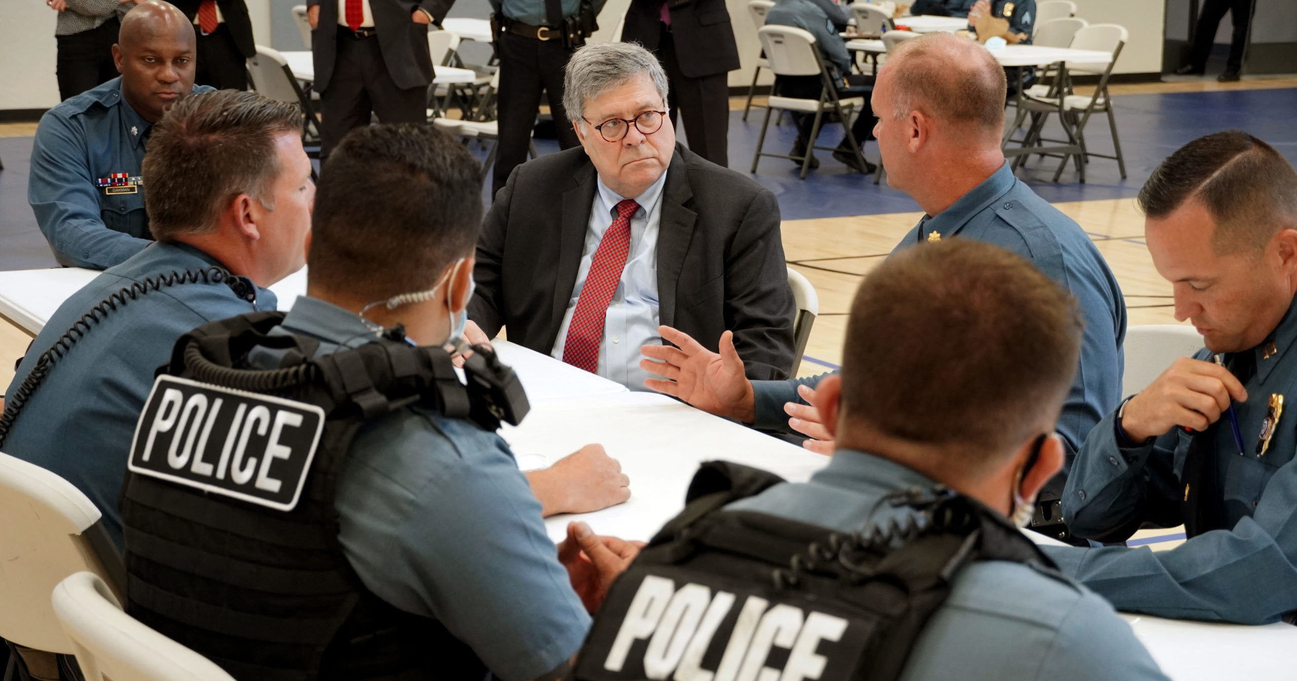 In this Aug. 19, 2020, photo, Attorney General William Barr speaks with police officers from the Kansas City Police Department in Kansas City, Missouri.
