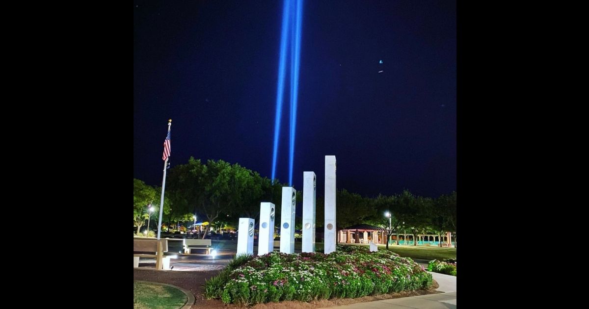 Patriotic tunes, emotional testimonials and two beams of light filled the air over the north Phoenix suburbs Friday night, as a local coffee shop honored those 2,977 people who lost their lives in the the Sept. 11, 2001, terrorist attacks.
