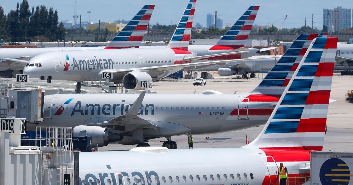 American Airlines aircraft are shown parked at their gates at Miami International Airport in Miami on April 24, 2019.