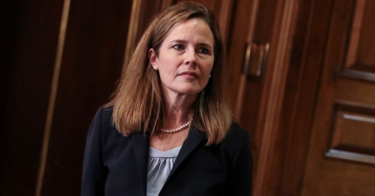Seventh U.S. Circuit Court Judge Amy Coney Barrett, President Donald Trump's nominee for the Supreme Court, meets with Indiana Republican Sen. Mike Braun as she prepares for her confirmation hearing, on Capitol Hill on Wednesday in Washington, D.C.