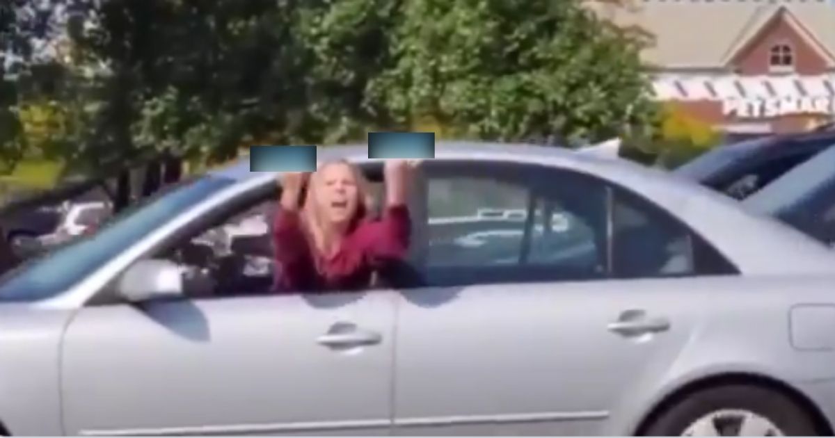 A driver's anti-Donald Trump tirade appears to have caused her to accidentally take her foot off the brake and nearly rear-end the car in front of her, according to a video that went viral on social media this week.