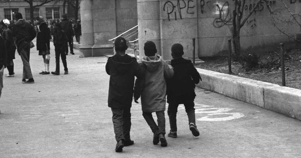 Three children walk to school in the South Side neighborhood of Chicago in 1968.