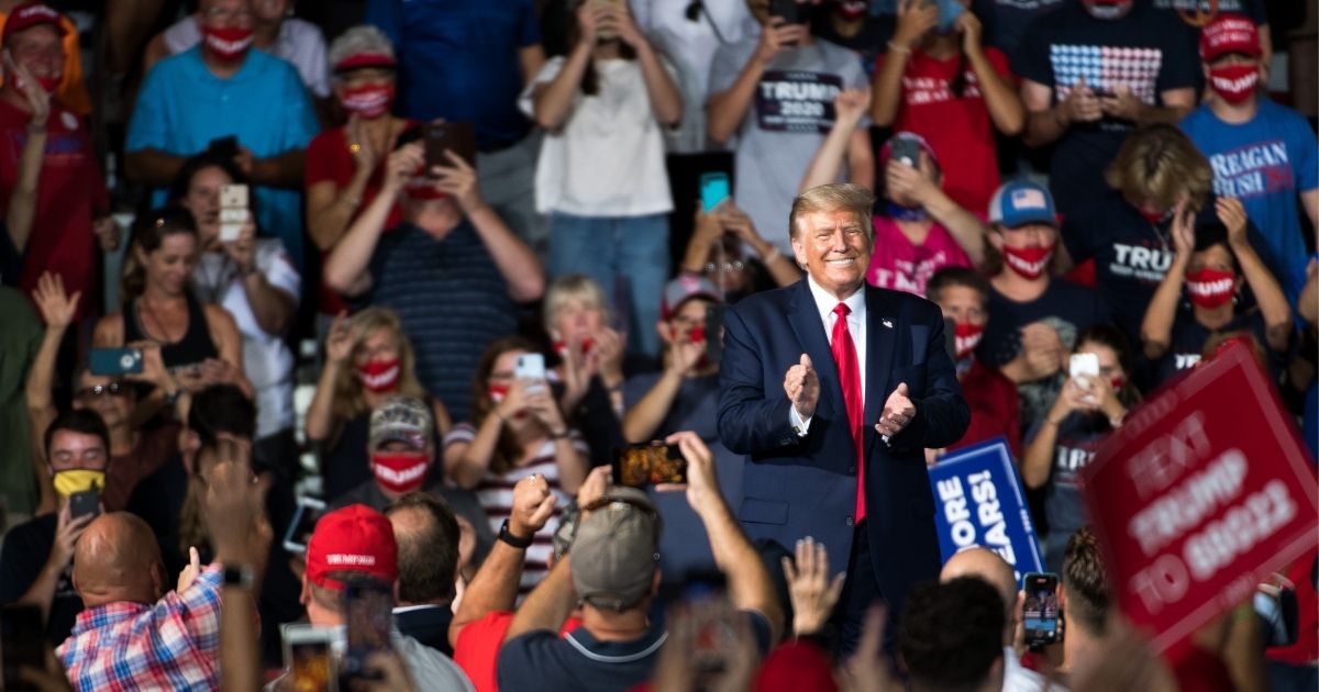President Donald Trump applauds with the crowd during a campaign rally at Smith Reynolds Airport in Winston-Salem, North Carolina, on Sept. 8, 2020.