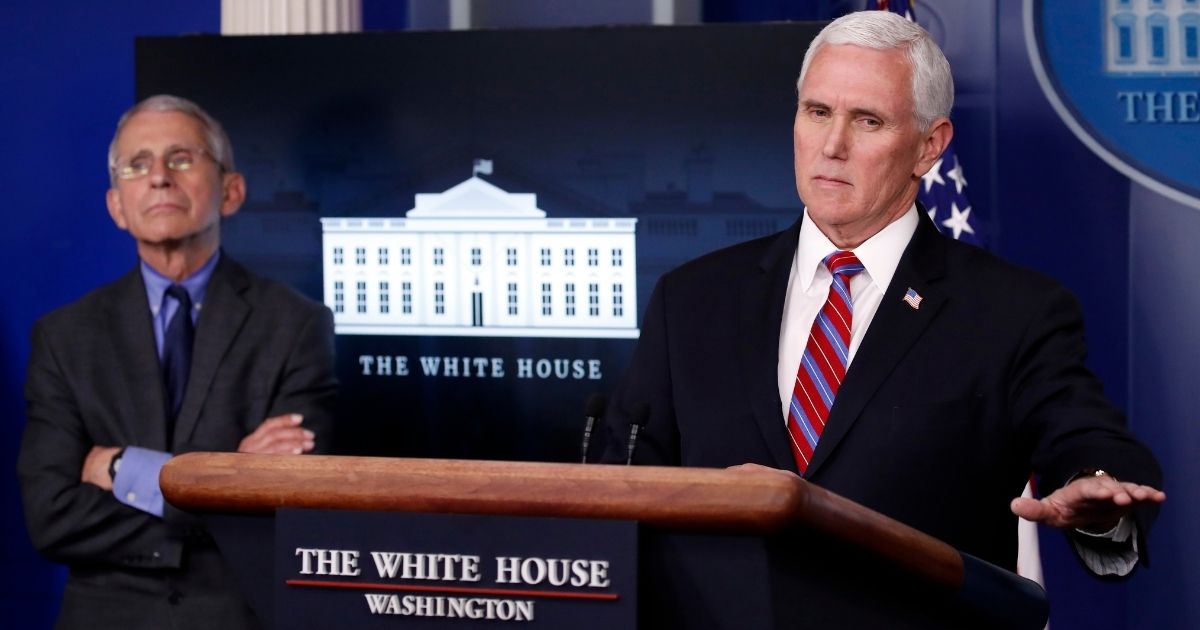 Dr. Anthony Fauci, director of the National Institute of Allergy and Infectious Diseases, listens as Vice President Mike Pence speaks about the coronavirus at the White House in Washington on April 13, 2020.