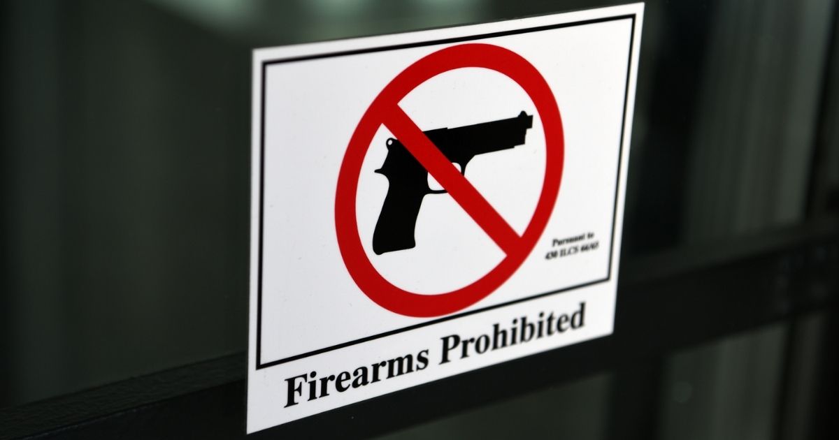 A "firearms prohibited" sign is shown in the above stock photo.