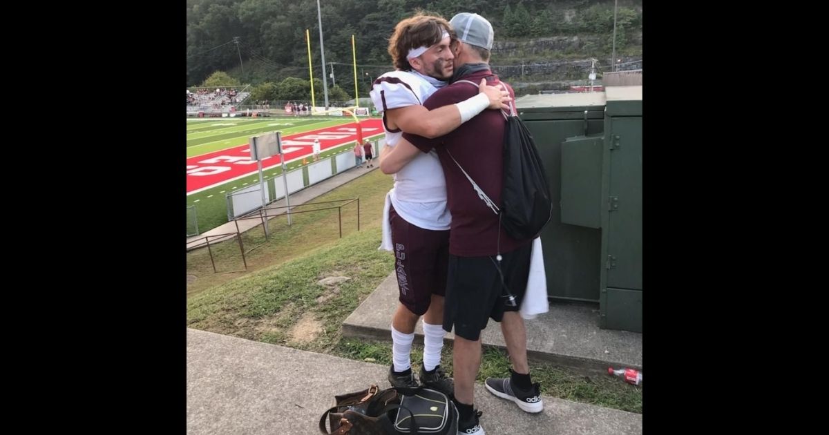 Cade hugs his father, Scott Sullivan, before the game.