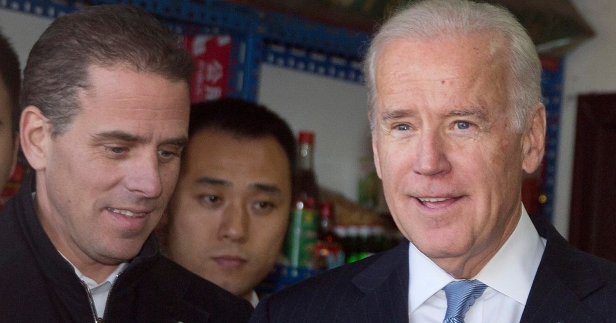 Hunter Biden, left, and his father, then-Vice President Joe Biden, tour a Hutong alley in Beijing on Dec. 5, 2013.
