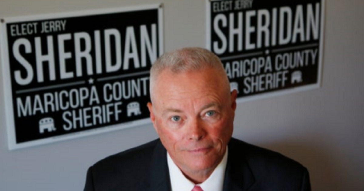Jerry Sheridan, with "Elect Jerry Sheridan" posters in the background.