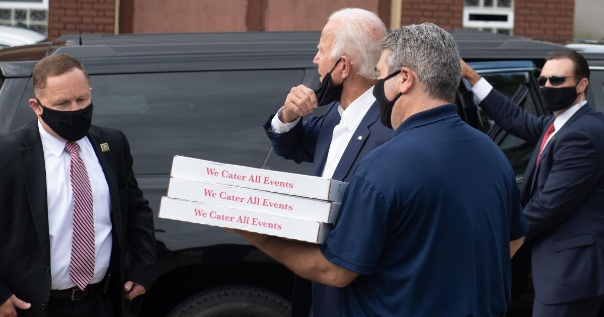 Democratic presidential nominee Joe Biden listens to a supporter of President Donald Trump as the former vice president makes a stop to deliver pizzas to a Pittsburgh firefighters union Aug. 31, 2020.