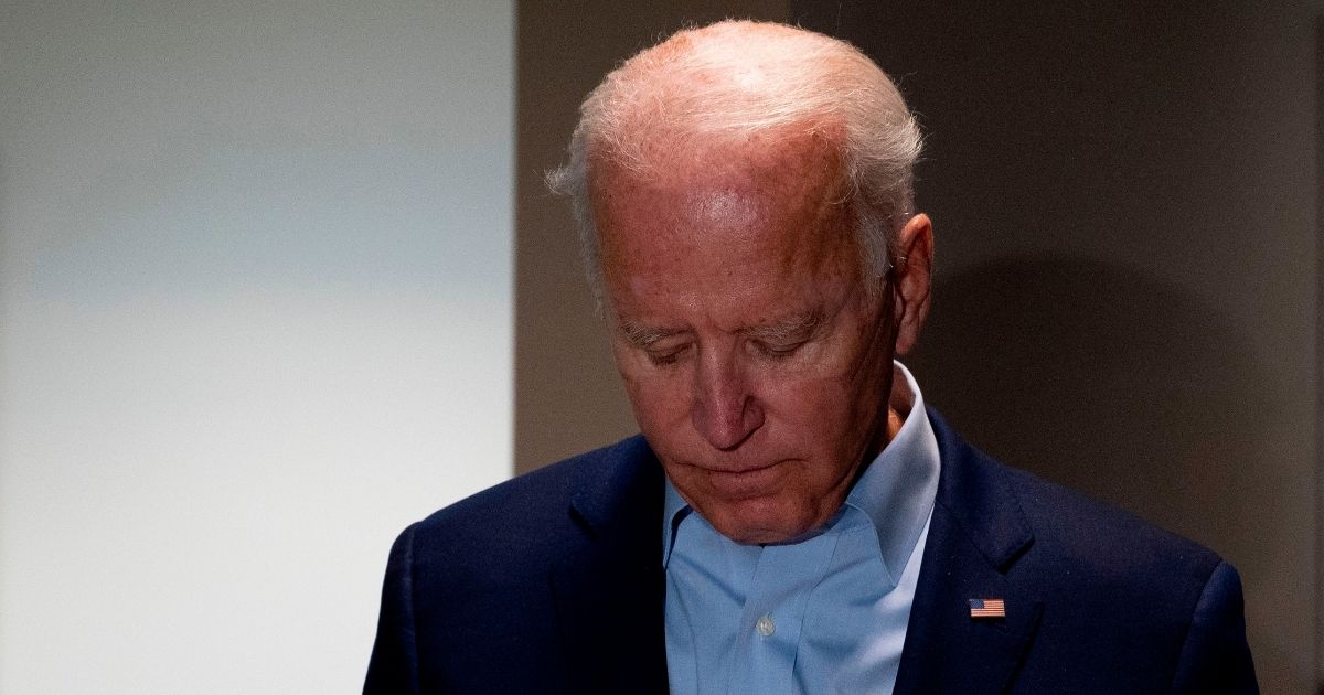 Democratic presidential nominee Joe Biden looks down as he delivers a statement on the passing of Supreme Court Justice Ruth Bader Ginsburg upon landing in New Castle, Delaware, on Sept. 18, 2020.