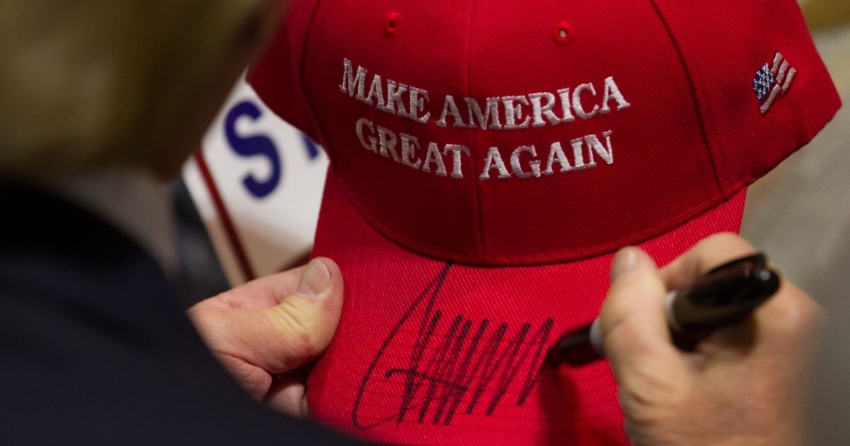 Then-presidential candidate Donald Trump signs a MAGA hat after speaking at a rally at the Connecticut Convention Center on April 15, 2016, in Hartford, Connecticut.