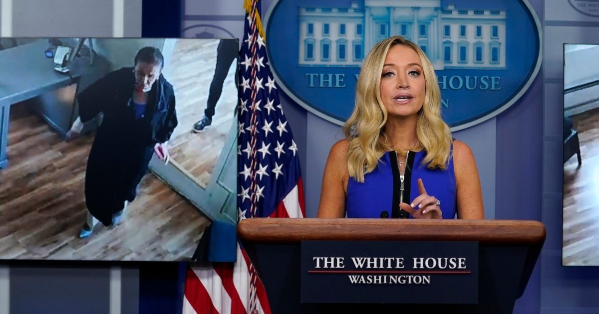 With a video of House Speaker Nancy Pelosi breaking local coronavirus restrictions at a hair salon displayed behind her, White House press secretary Kayleigh McEnany speaks during a news briefing at the White House on Sept. 3, 2020.