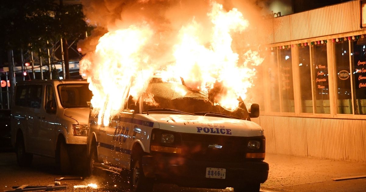 FDNY firefighters work to put out fires on NYPD vehicles caused by rioters near Union Square on May 30, 2020, in New York City.
