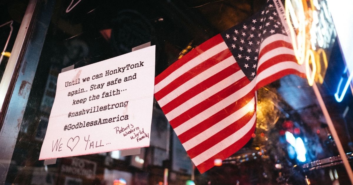 A sign is posted on the door of a bar in Downtown Broadway is seen at night on April 8, 2020, in Nashville, Tennessee.