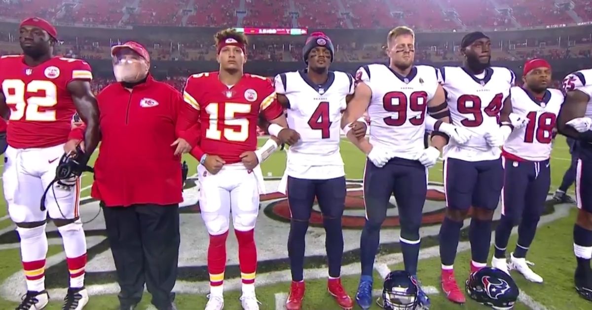 NFL players and coaches from the Houston Texans and Kansas City Chiefs link arms before the opening game of the 2020-2021 NFL season.