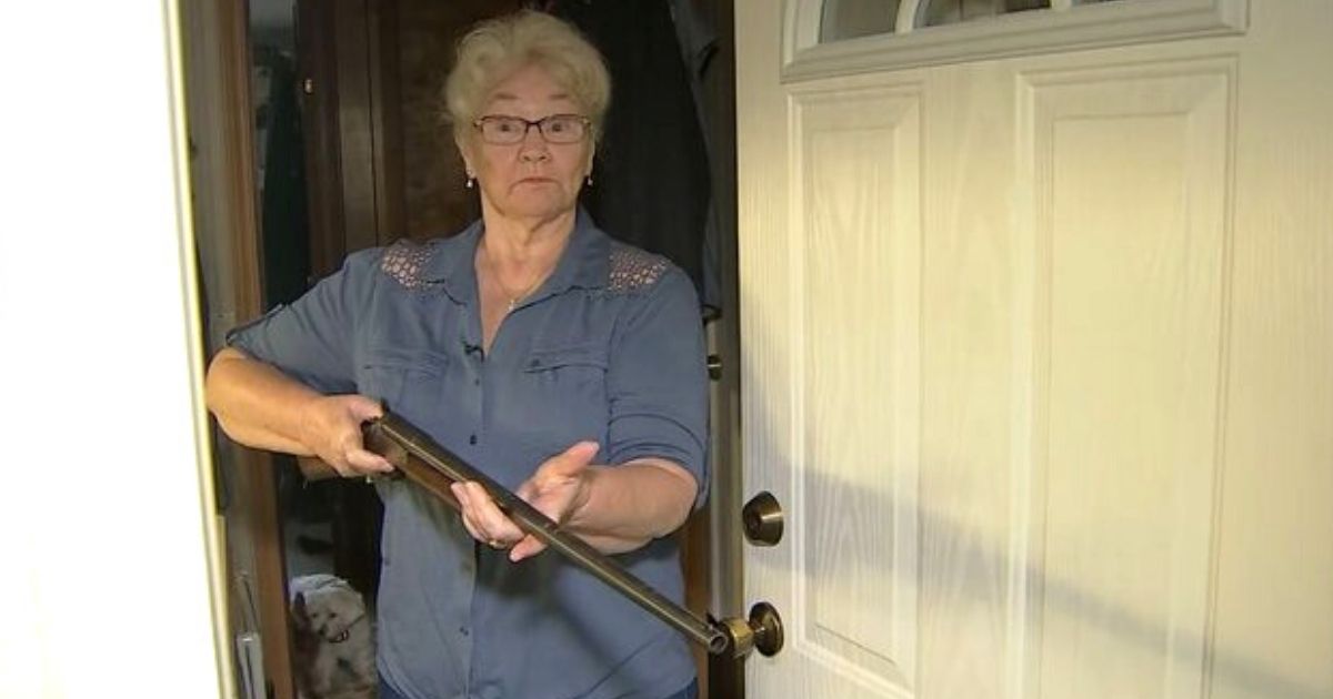 Sandy, a 78-year-old Washington state woman, holds her gun in the doorway.
