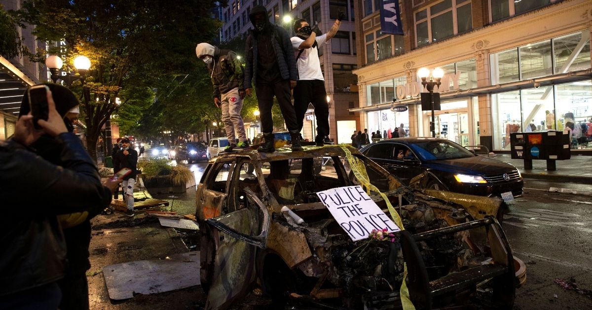 People riot in the streets on May 30, 2020, in Seattle, Washington.